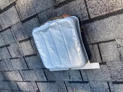 Hail impact marks and dents on an asphalt shingle roof