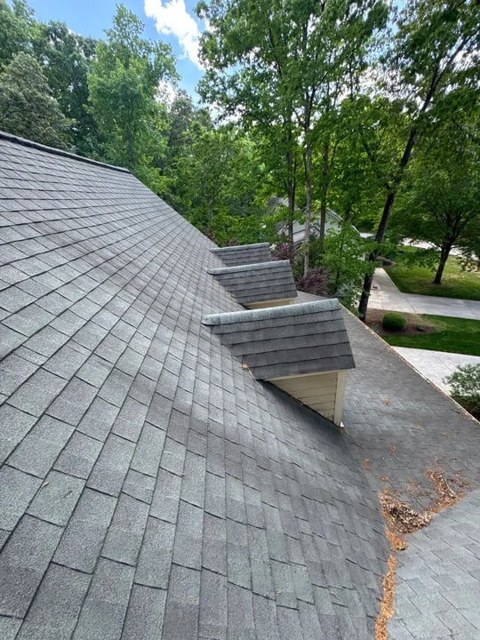 On Tops Roofing team member performing a roof inspection on a Cary, NC home