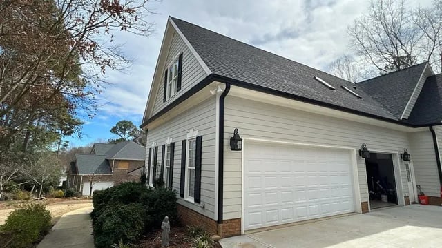 Front exterior of a home with newly installed gutters along the roofline
