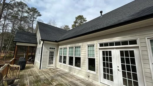 Home in Apex with newly installed black 6-inch gutters along the roofline