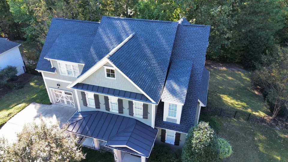 Close-up of a finished roof repair section on Capulin Crest Rd in Apex, NC with matching GAF Charcoal shingles