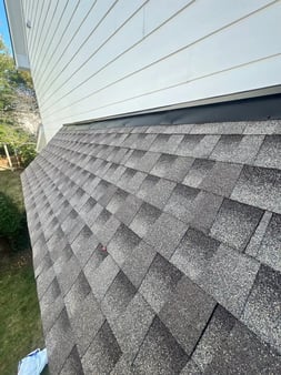 Close-up of newly installed GAF Timberline HDZ charcoal architectural shingles on a Cary, NC home
