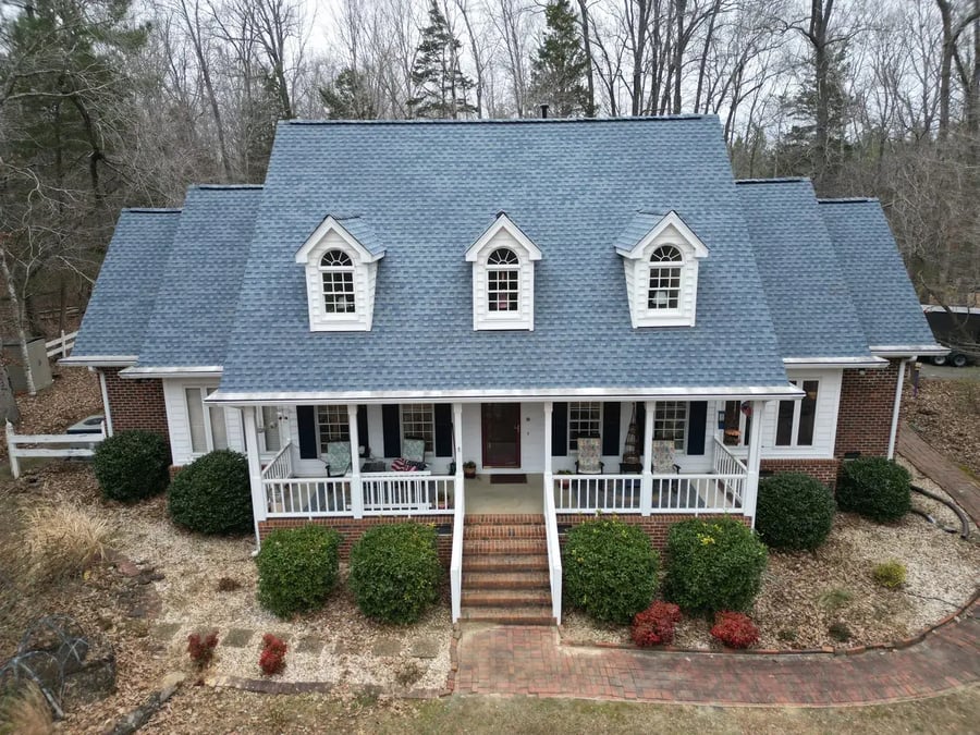 GAF Timberline HDZ Biscayne Blue shingles on a painted white brick Cape Cod with three pediment-topped dormers in Hillsborough, NC