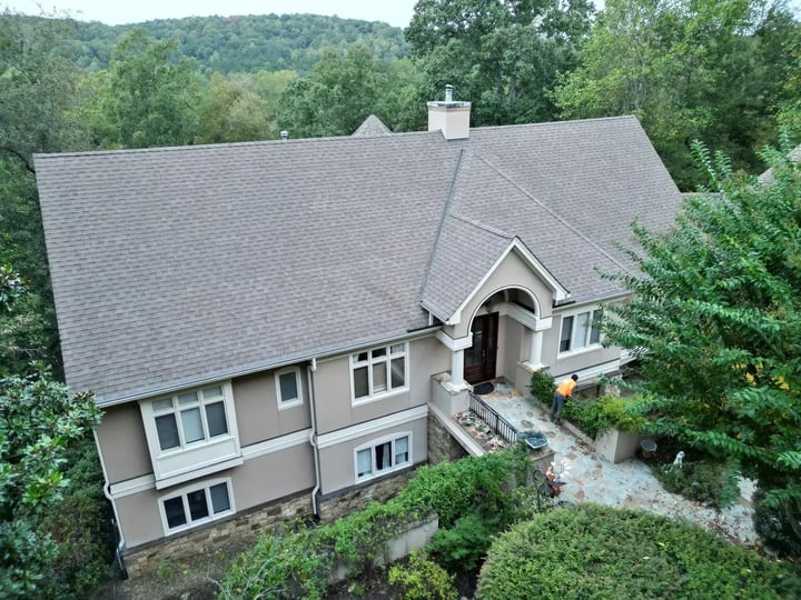 Aerial completion view of Chapel Hill roof replacement at Governors Club with new gray shingles, white trim, and cupola