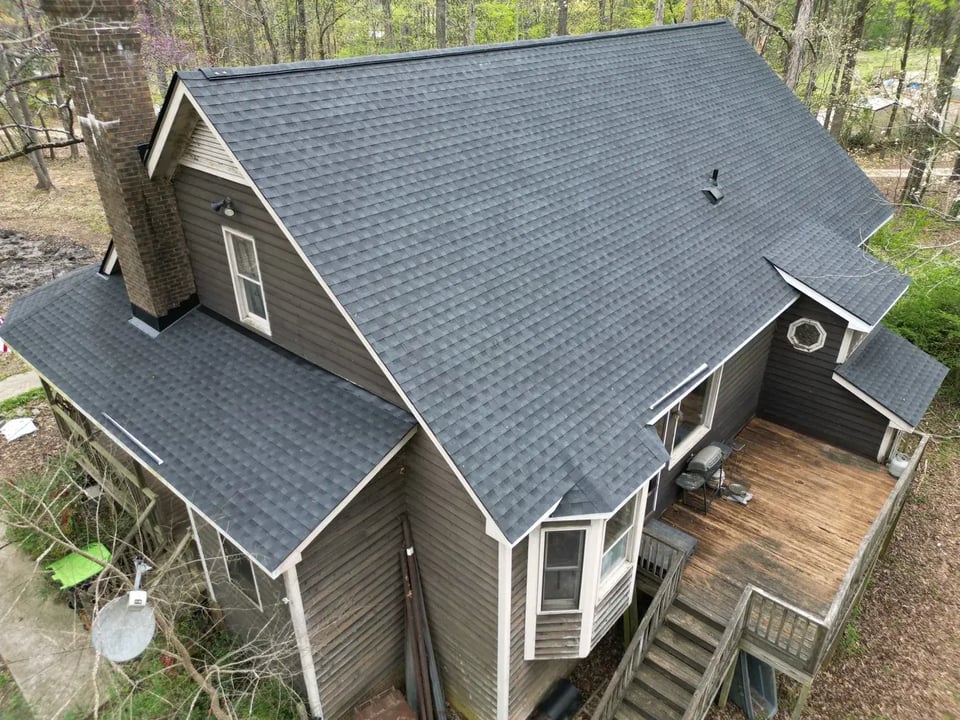 Close-up of a finished roof repair section on Loblolly Cir in Clayton, NC with matching GAF Charcoal shingles