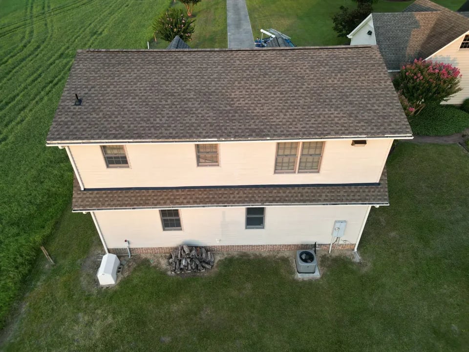Close-up of a finished roof repair section on Christmas Tree Rd in Dunn, NC with matching GAF Weathered Wood shingles