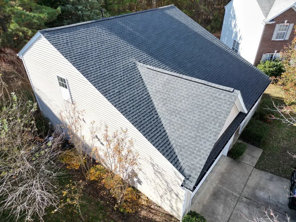 On Tops Roofing team member performing a roof inspection on a Durham, NC home
