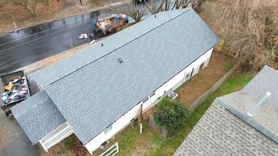 On Tops Roofing technician performing a targeted roof repair on a Durham, NC home
