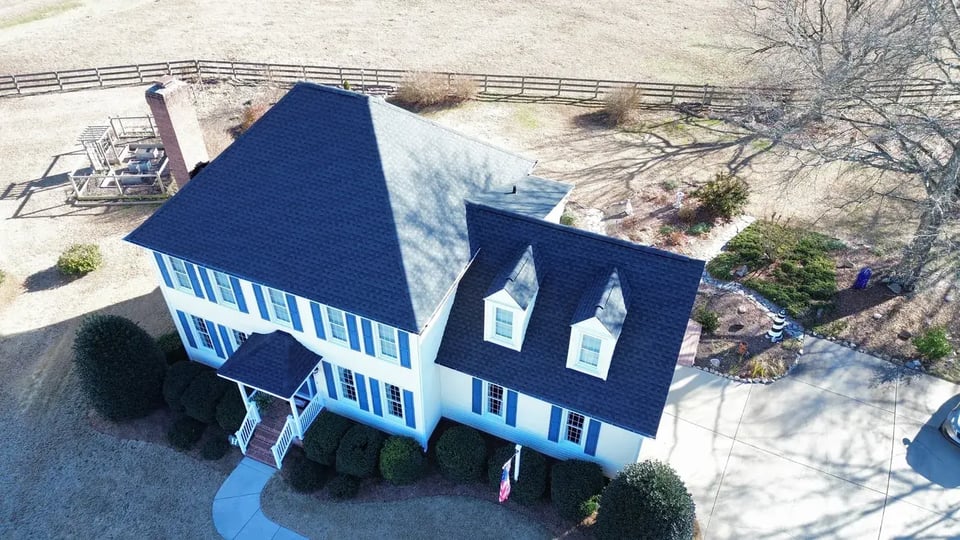 Close-up of a finished roof repair section on Larimer Ct in Fuquay-Varina, NC with matching GAF Charcoal shingles