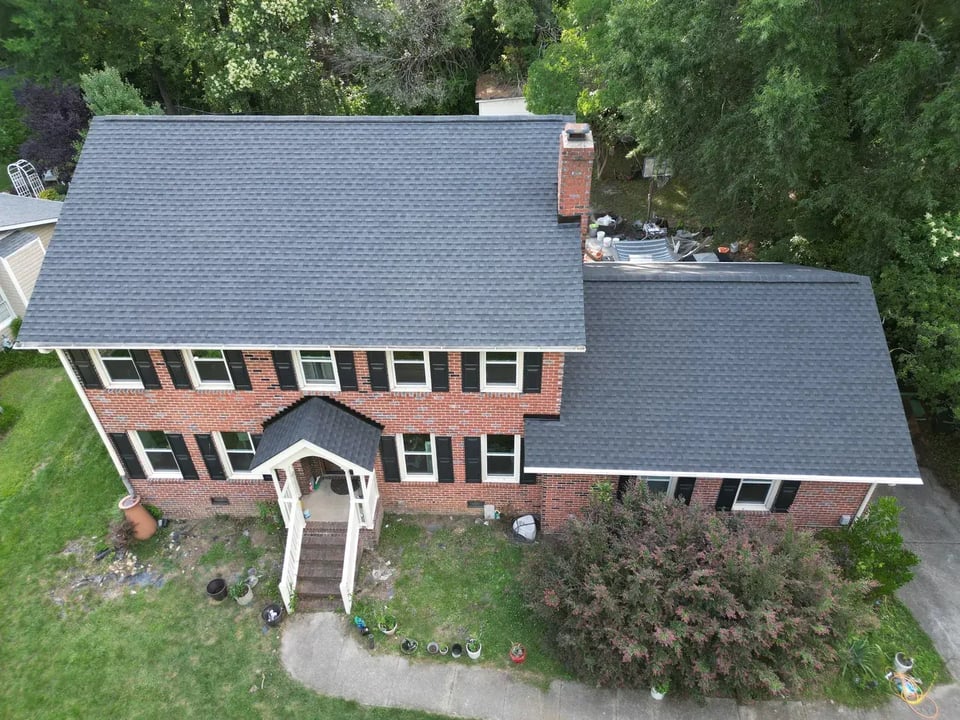 Close-up of a finished roof repair section on Buckingham Rd in Garner, NC with matching GAF Charcoal shingles