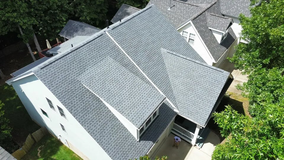 Close-up of a finished roof repair section on Marsh Landing Dr in Holly Springs, NC with matching GAF Pewter Gray shingles