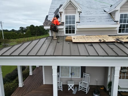 Completed roof replacement with algae-resistant shingles on a Holly Springs, NC home surrounded by wooded landscaping