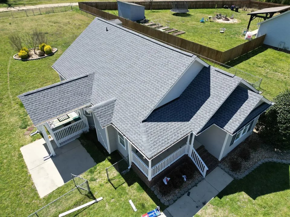Close-up of a finished roof repair section on Letcher Ln in Lillington, NC with matching GAF Oyster Grey shingles