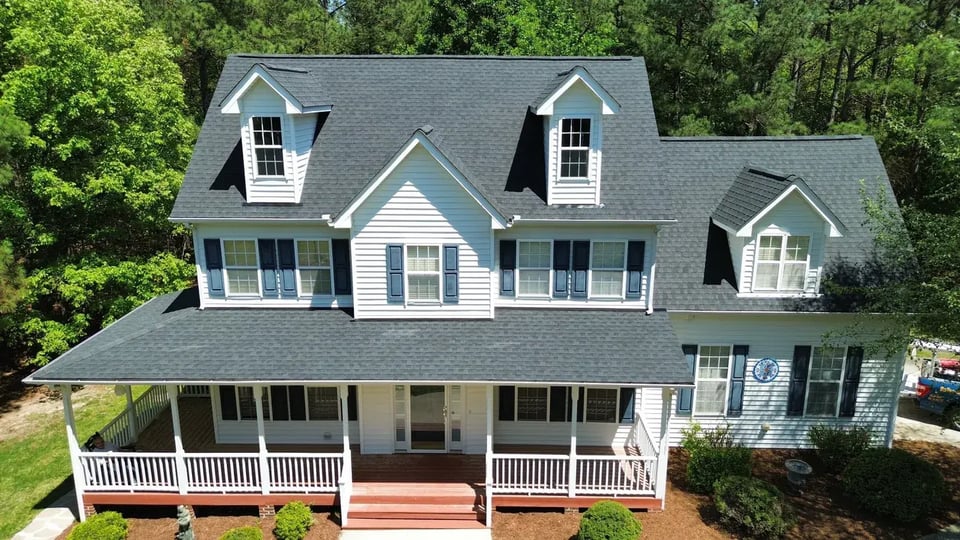 Close-up of a finished roof repair section on Poplar Forest Ln in Pittsboro, NC with matching GAF Charcoal shingles