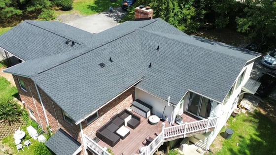 Charcoal GAF HDZ shingles on a single-story brick ranch with cedar-shake gable accents in Raleigh on Campbell Rd