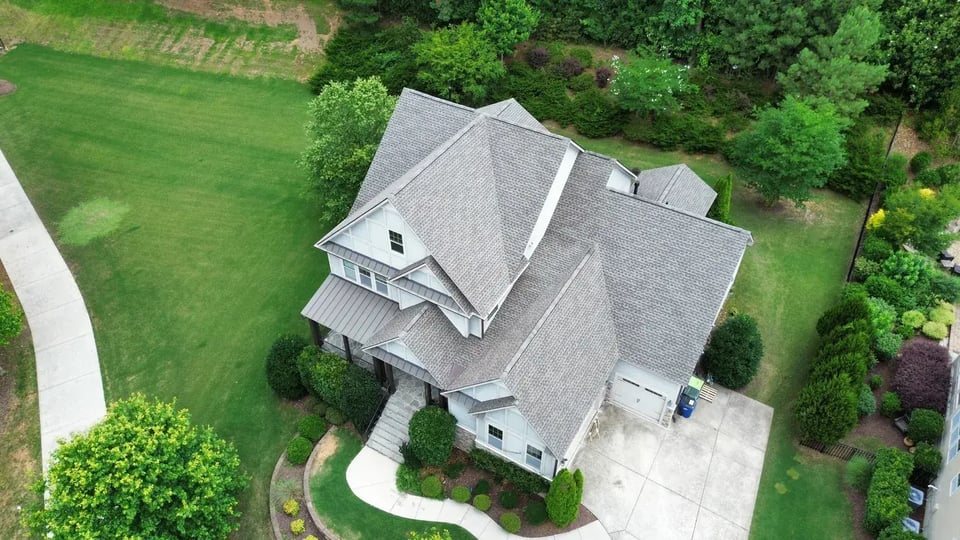 Completed Weathered Wood GAF HDZ shingle roof on a large two-story Raleigh home with a complex layered roofline