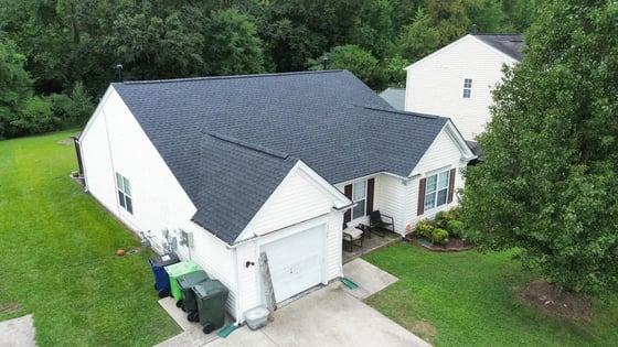 Charcoal GAF HDZ shingles on a single-story white vinyl ranch home in Raleigh on Tuckland Rd