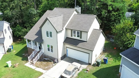 Weathered Wood GAF HDZ shingles on a cream two-story Raleigh home on Wildoat Place