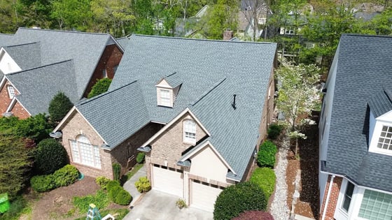 Slate GAF HDZ shingles on a two-story brick Raleigh home with covered front porch on Yorkchester Way