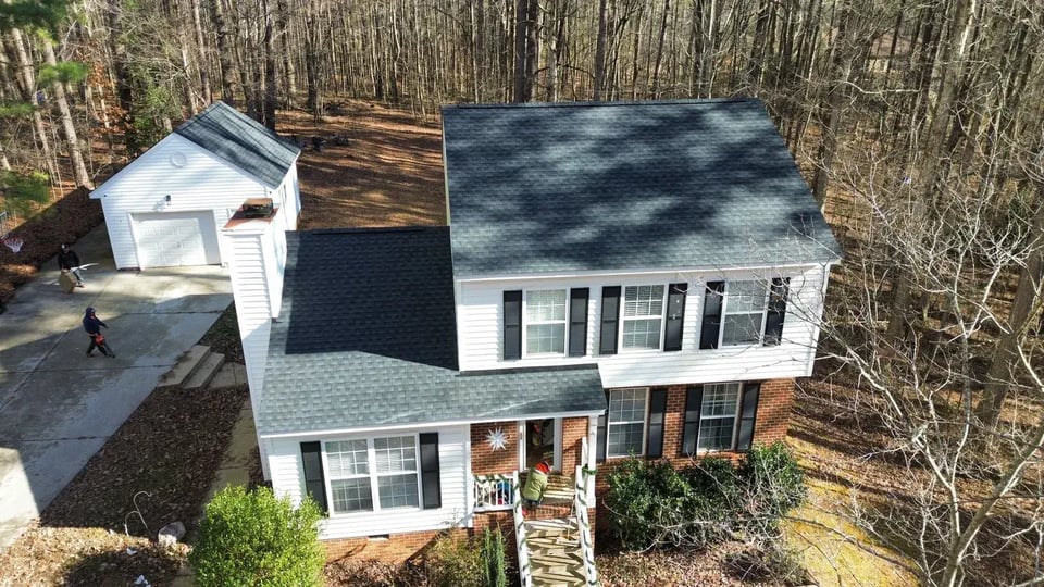 Close-up of a finished roof repair section on Roseanne Dr in Wake Forest, NC with matching GAF Charcoal shingles