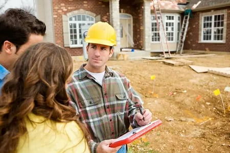 a roofer showing a couple their roofing estimate