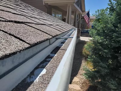 asphalt shingle granules in a gutter