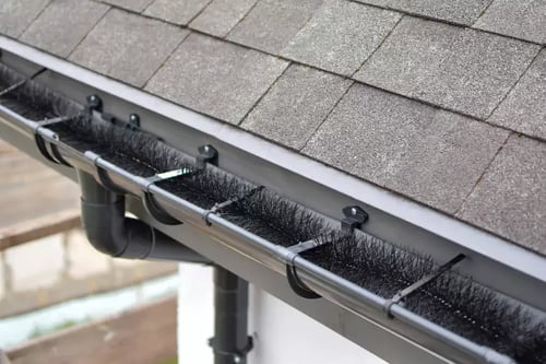 black spiky gutter guard sitting in gutter