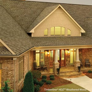 brown architectural asphalt shingles on a beige brick house