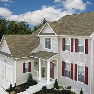 brown three-tab shingles on a white house with red shutters_WebP