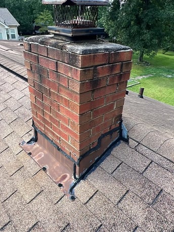 Brick chimney with flashing on a residential roof
