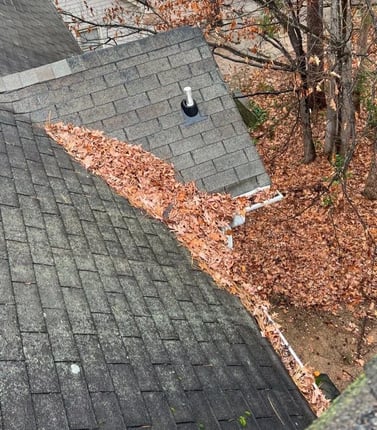 Clogged gutters overflowing with leaves and debris
