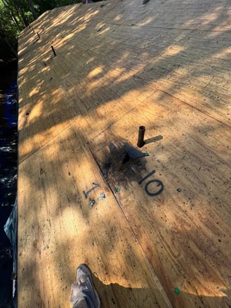 Water damage on a roof around a plumbing pipe penetration