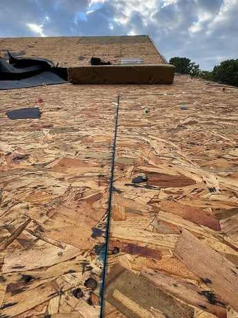 Roof decking boards beneath the roofing material