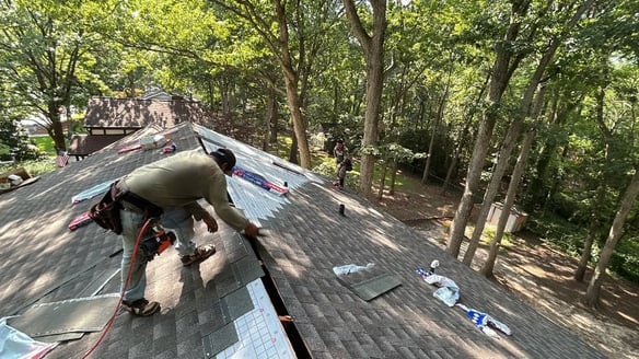 Roofing crew working carefully on a residential roof