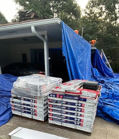 Roofing materials delivered near a driveway