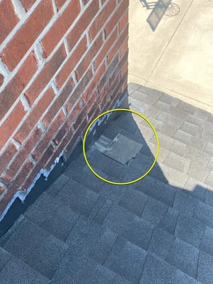 A roof with a missing shingle
