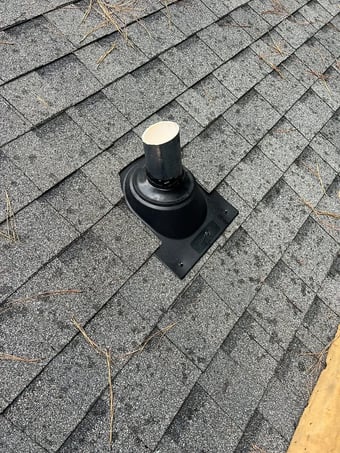 Pipe boot sealing a plumbing vent on a shingle roof