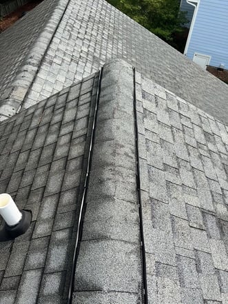 Ridge vent running along the peak of a shingle roof