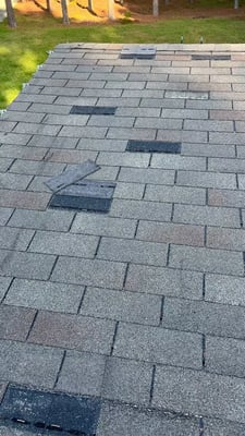 A roof with missing shingles