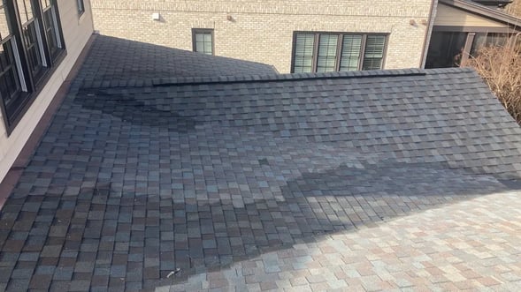 Melting snow pooling near the edge of a roof