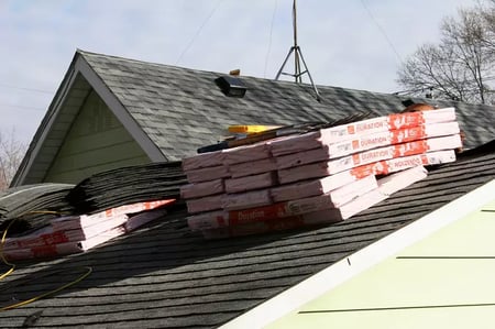 stacks of packaged shingles on a roof