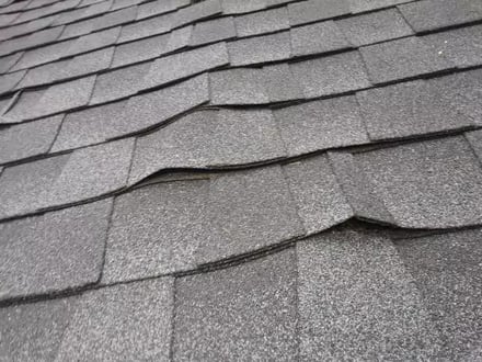 Warped shingles from a poor installation
