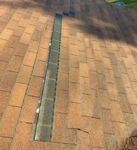 Roof shingles lifted and creased by high winds