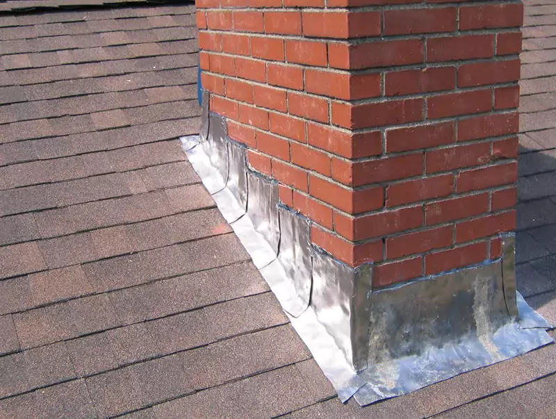 Flashing around a brick chimney on an asphalt shingle roof