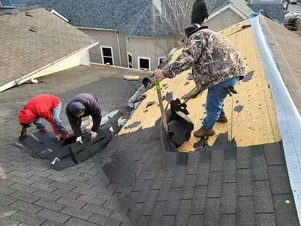 Roofers scraping off the old shingles