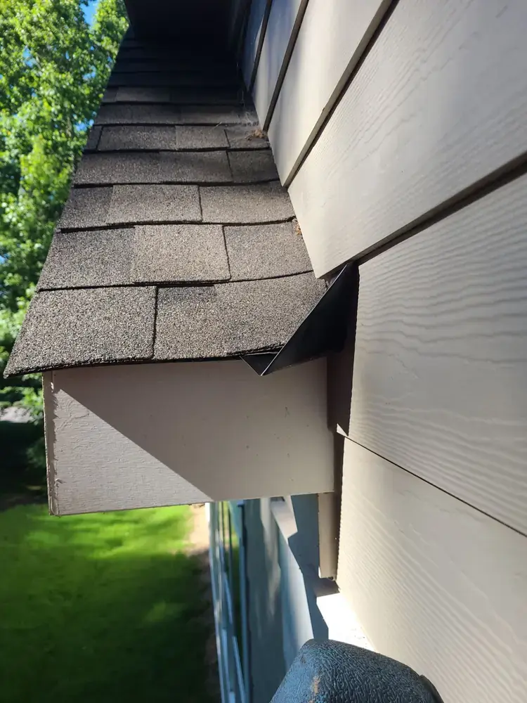 Kick-out flashing installed at roof-to-wall transition to divert water into gutter