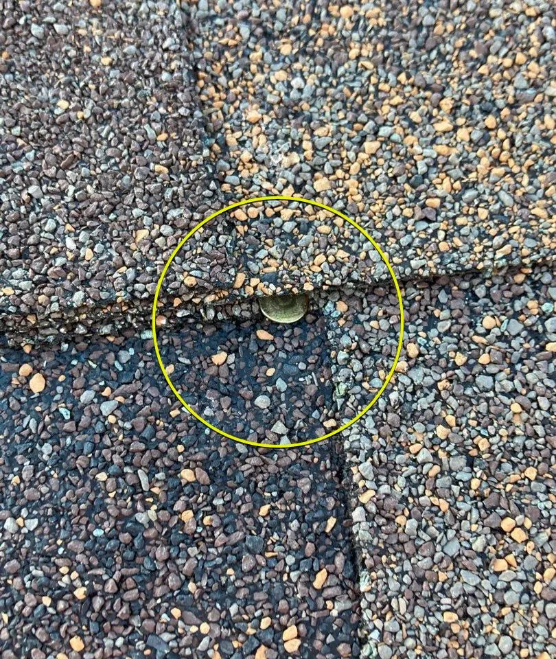 Improperly nailed shingles from a cut-rate installation