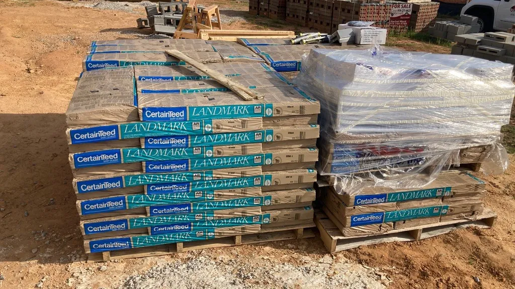 Roofing materials staged and waiting for installation at a job site
