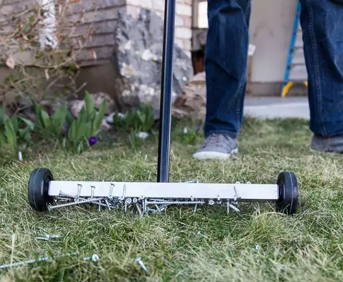 Sweeping the yard with a magnet, looking for nails