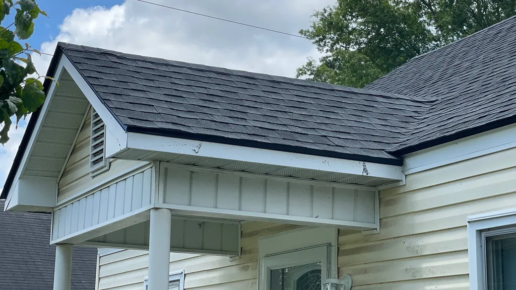 Well maintained asphalt shingle roof with clean gutters on a North Carolina home